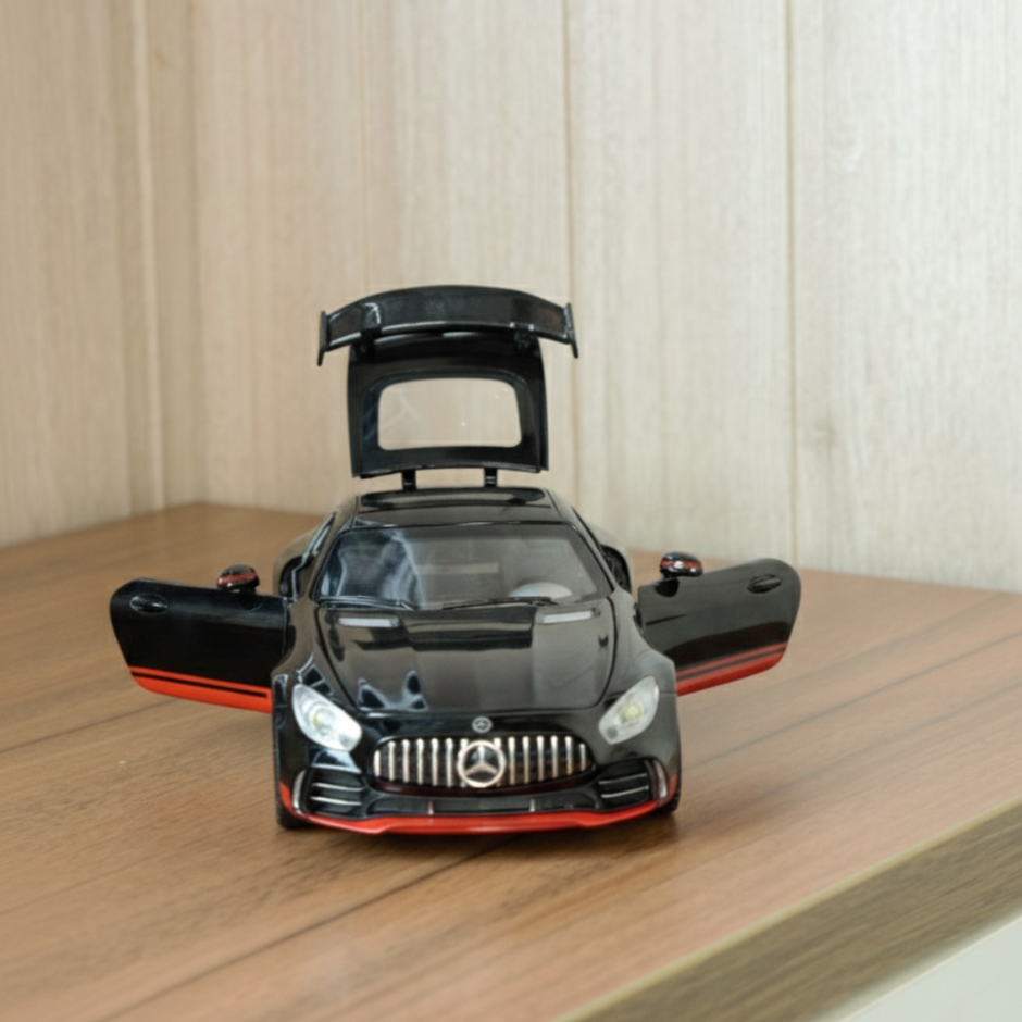 Black 1:24 die cast sports car with openable doors and rear engine cover showing internal detail
