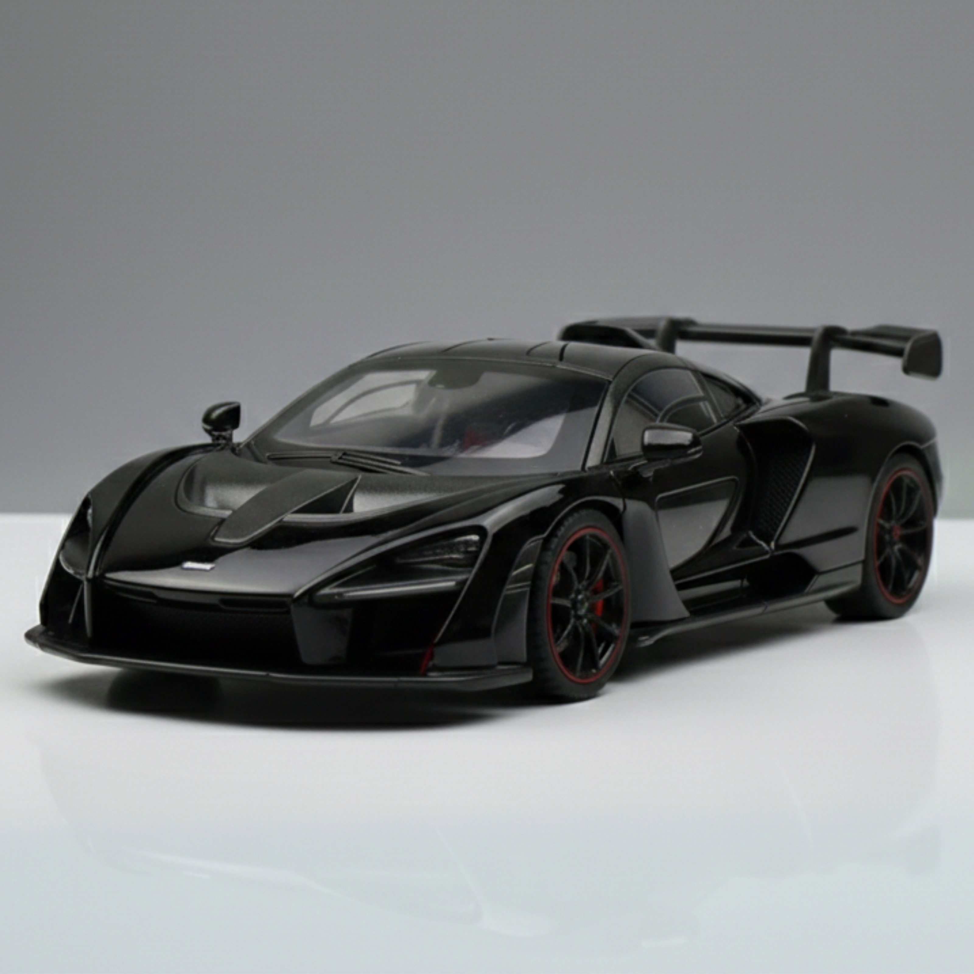 Black sports car model on a gray background