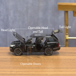 Black toy SUV with labeled features on a wooden surface
