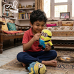 Child playing with a plush toy in a living room, with BIS Approved logo.
