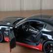 Claptales black die cast sports car with open driver door showing detailed interior

