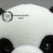 Close-up of a panda plush toy with 'Premium Quality Fabric' label.