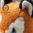 Close-up of a plush toy with 'Premium Quality Fabric' label