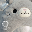Close-up of a plush toy with a 'Premium Quality' label on a light gray background