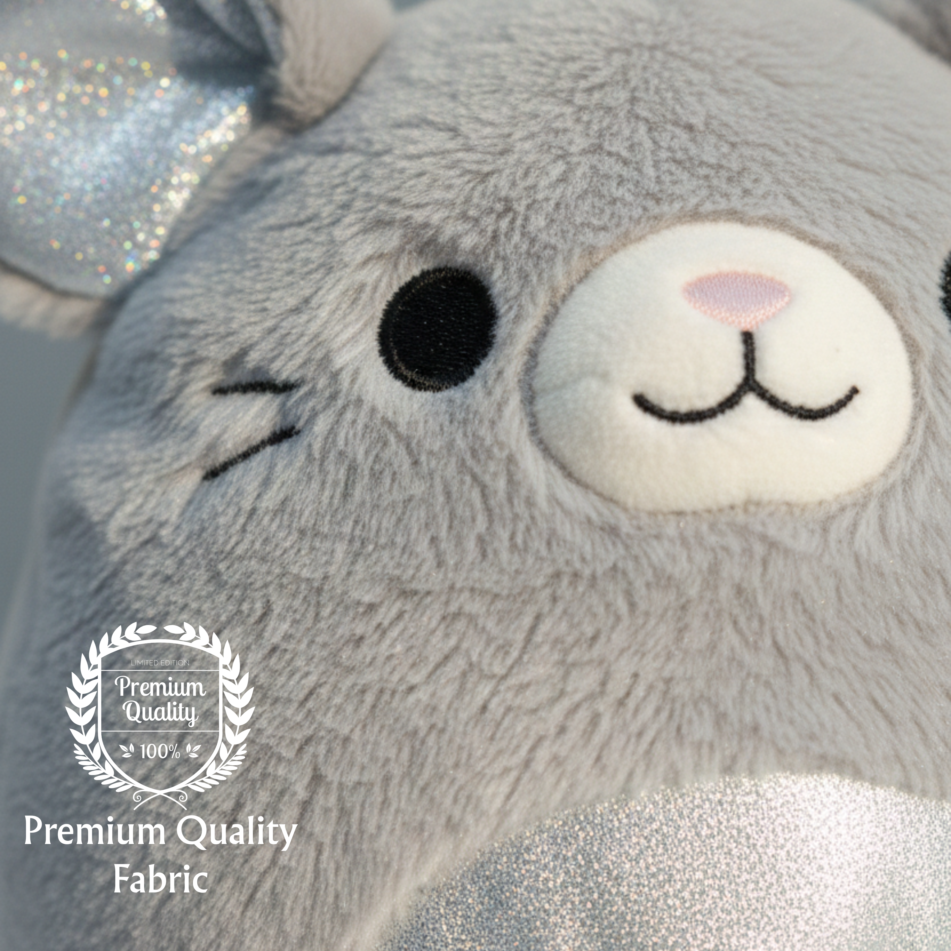Close-up of a plush toy with a 'Premium Quality' label on a light gray background