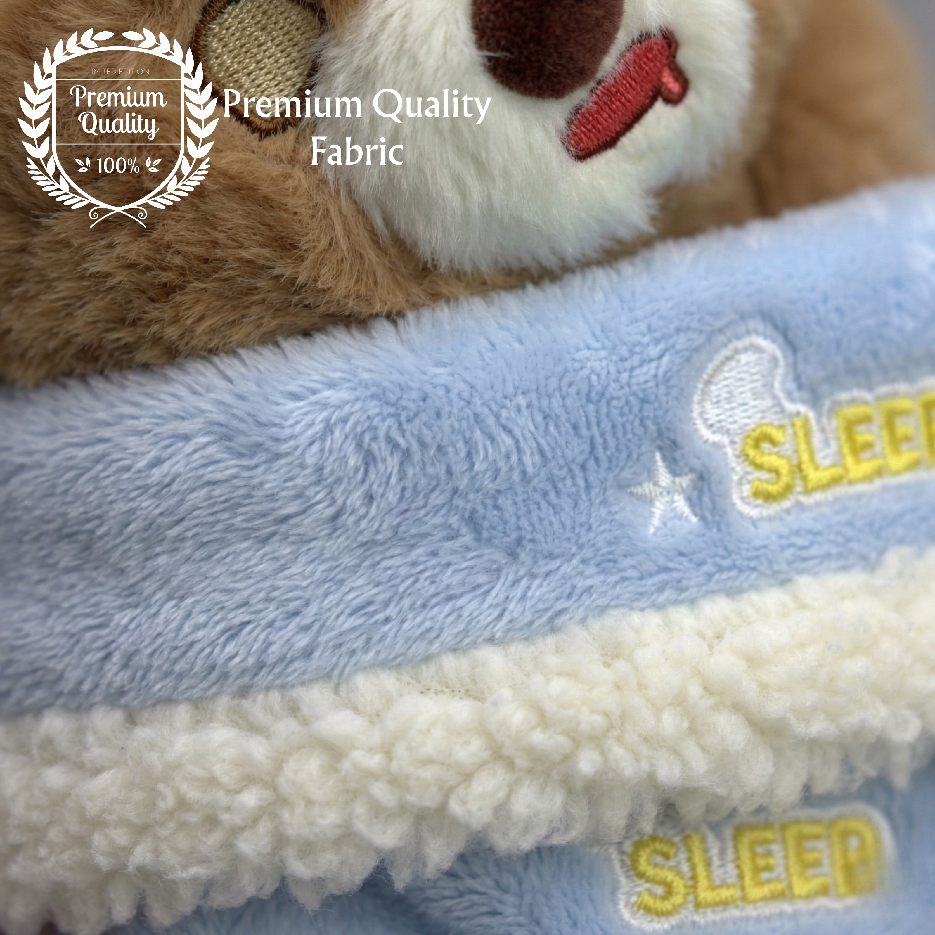Close-up of a plush toy with a blue blanket labeled 'Sleep' on a soft fabric background.