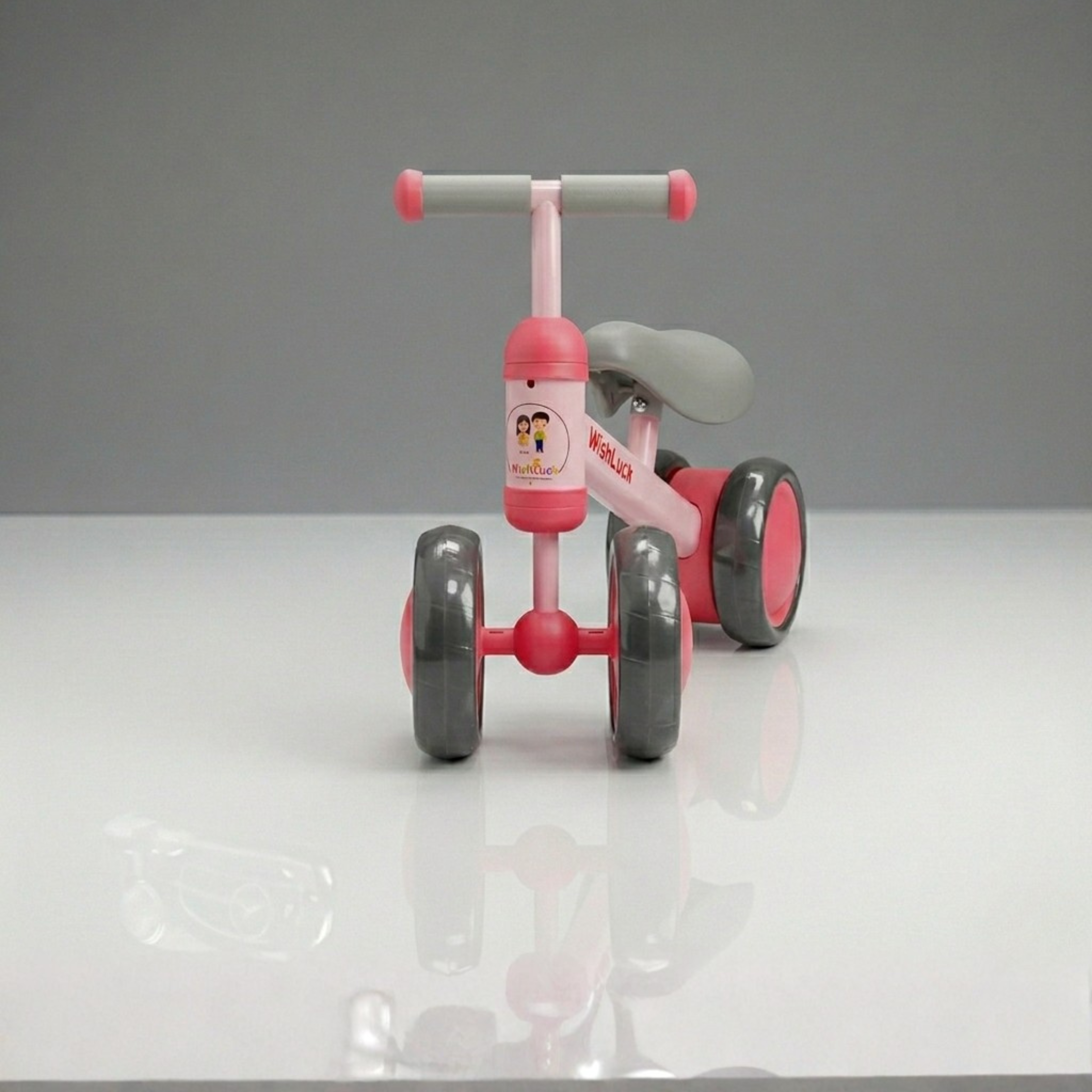 Front view of baby balance bike showing stable 4 wheel scooter design for kids