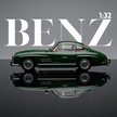 Front view of green 1:32 die cast classic car with large text benz in the background