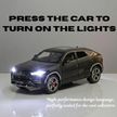 Model car with illuminated headlights on a grey background