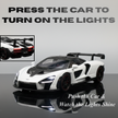 Model car with instructions to press it for lights on a reflective surface