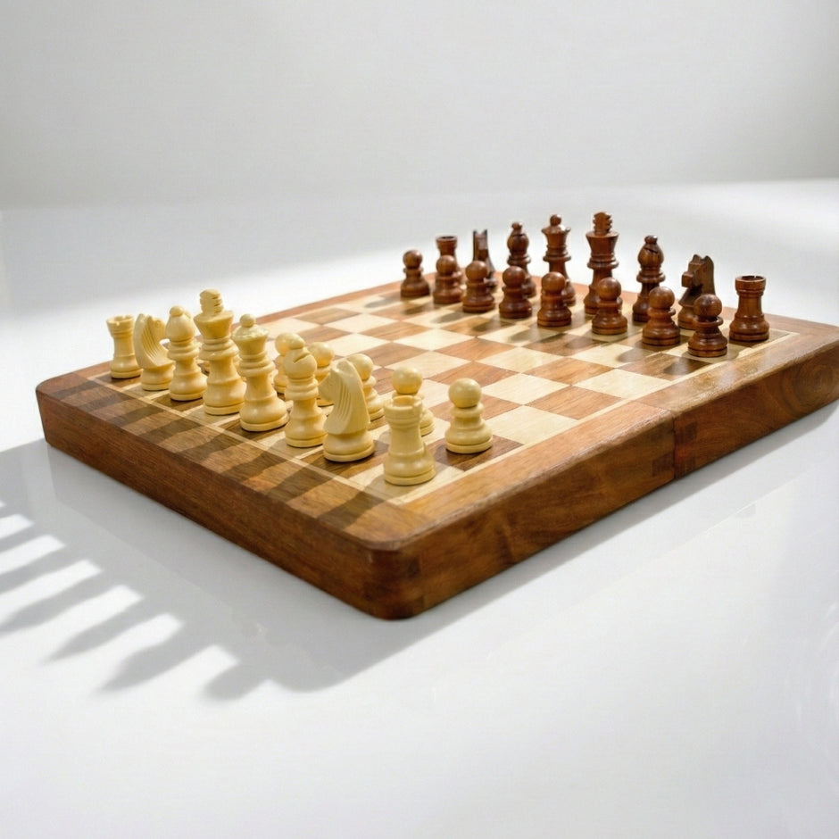 Open compact wooden magnetic chess board showing arranged chess pieces for gameplay