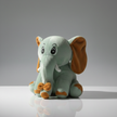 Plush elephant toy on a reflective surface with a gray background