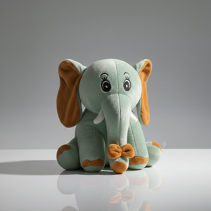 Plush elephant toy with a bow tie on a reflective surface and gray background