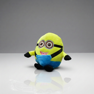 Plush toy resembling a character from a popular movie franchise on a reflective surface with a gray background