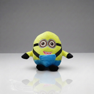 Plush toy resembling a character from a popular movie on a reflective surface with a gray background