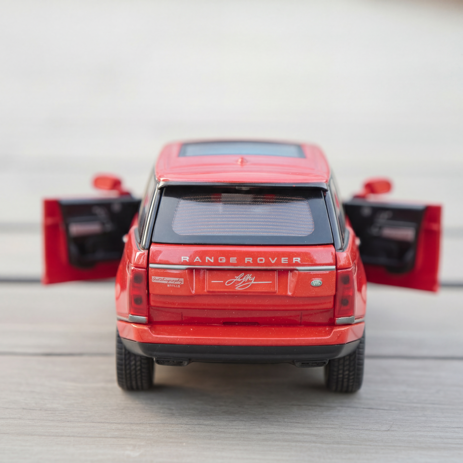 Red model Range Rover with open doors on a light gray background