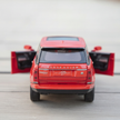 Red model Range Rover with open doors on a light gray background