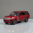 Red model car on a reflective surface with a gray background