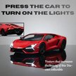 Red sports car model with illuminated headlights on a reflective surface, text indicating feature to press car for lights.