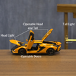 Yellow toy car with openable doors, headlight, tail light, and headlight labeled on a wooden surface.